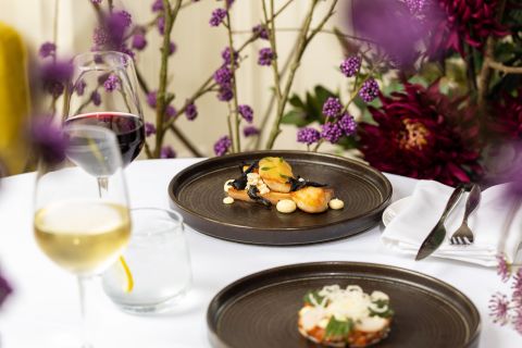 A Plate Of Food And Wine Glasses