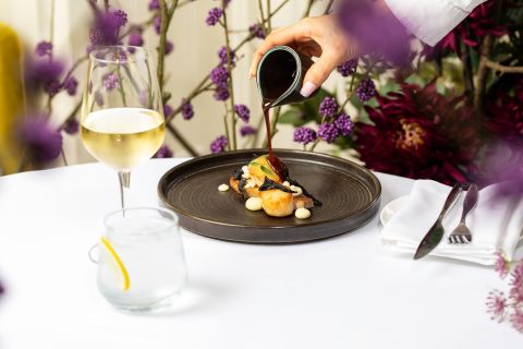 A Plate Of Food And Glasses Of Wine On A Table
